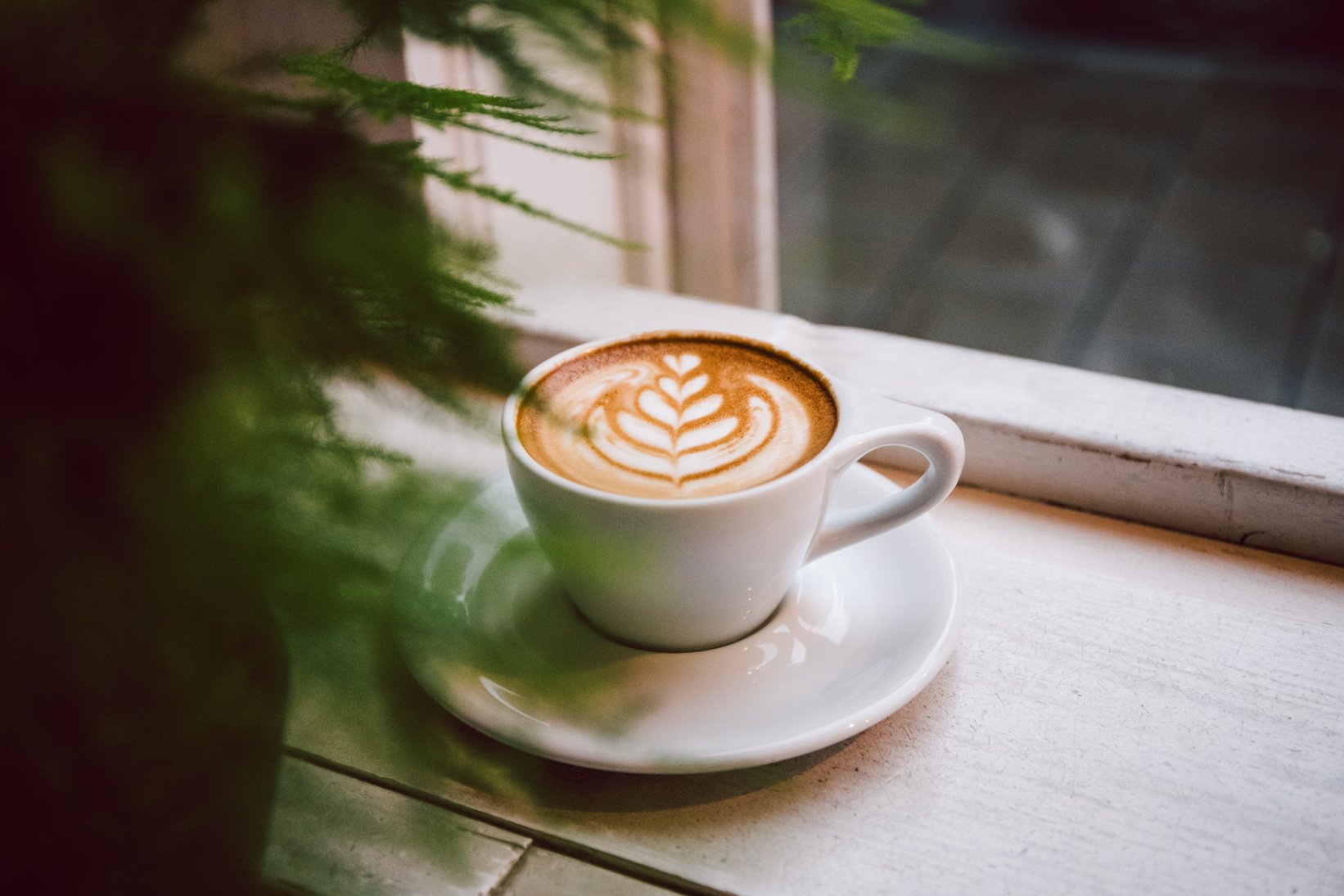 Cappuccino placed beside the window